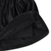 Girls’ black pleated skirt close-up showing inner shorts and elastic waistband detail.
