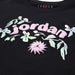 Jordan youth black t-shirt with pastel floral design and raised logo lettering on the chest.