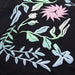 JOR-45F489-023 t-shirt close-up showing pastel floral print on black fabric
