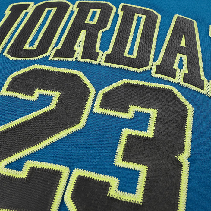 Close-up of a blue kids' jersey with large stitched black lettering and the number 23 outlined in yellow.