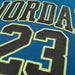 Close-up of a blue kids' jersey with large stitched black lettering and the number 23 outlined in yellow.