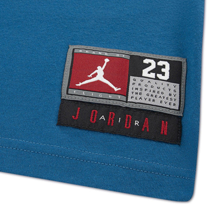 Jordan blue fabric close-up featuring Jumpman patch and number 23 on stitched label.