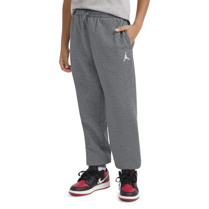 Jordan kids' grey sweatpants shown on a child with hands in pockets, front view.