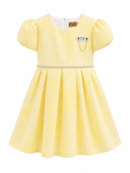Kids Energy yellow dress with puff sleeves and decorative waist detail shown on white background.