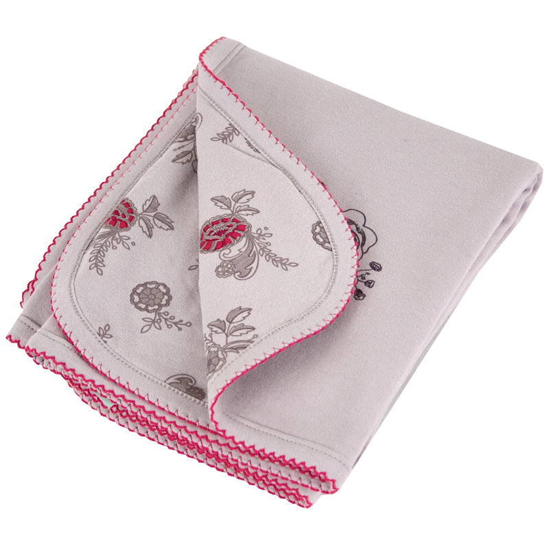 Baby blanket with pink and grey floral pattern, folded to show both sides of the fabric.