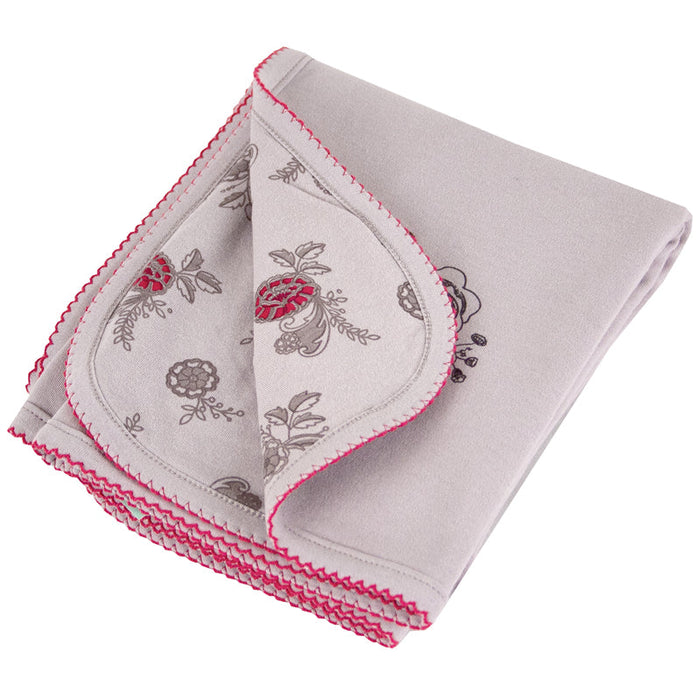 Baby blanket with pink and grey floral pattern, folded to show both sides of the fabric.