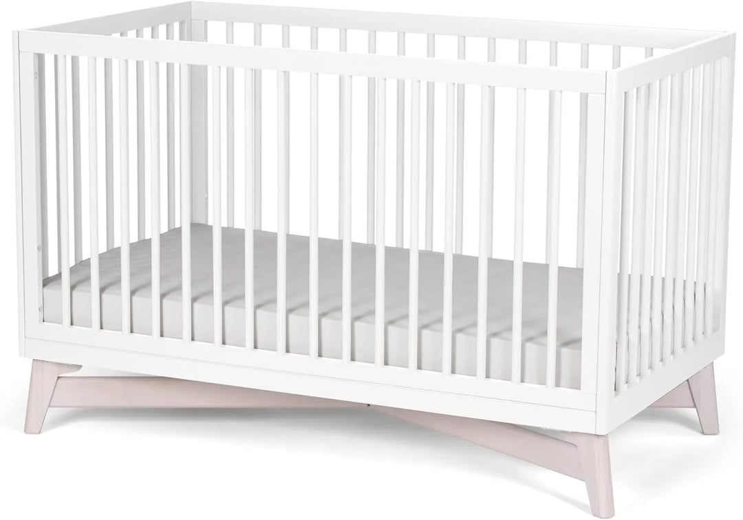 Little Seeds Pala 4-in-1 convertible crib in white with angled wood legs on a plain background.