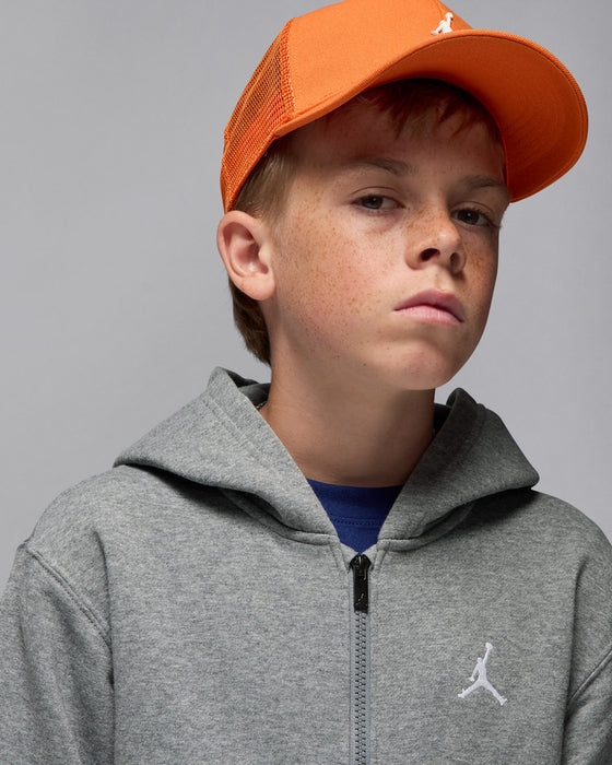 Jordan gray full-zip hoodie worn by a boy with an orange cap in a studio setting.