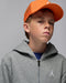 Jordan gray full-zip hoodie worn by a boy with an orange cap in a studio setting.