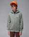 Jordan kids' grey zip-up hoodie with logo, modeled by a boy wearing an orange cap against a plain background.