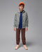 Jordan Brooklyn fleece zip hoodie worn by a boy standing against a plain studio backdrop.