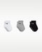 Nike baby gripper socks in white, grey, and black shown in a row on a plain background.