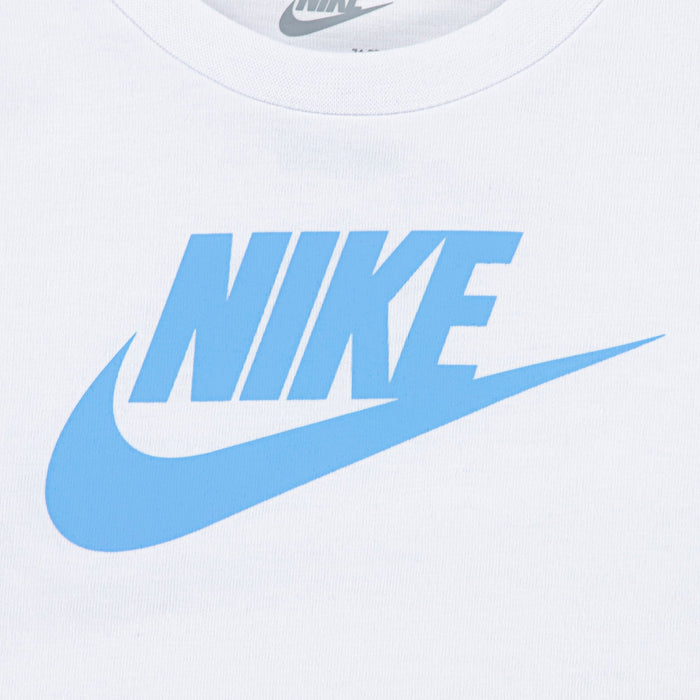 Nike kids' white shirt with blue logo shown in a close-up of the chest area.