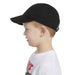 Nike kids' black baseball cap worn by a young boy, shown in profile on a white background.