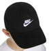 Nike black baseball cap with white logo worn by a child, viewed from above.