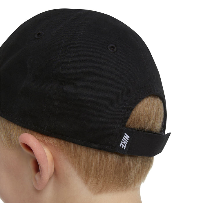 Nike black kids cap back view on child showing adjustable strap and embroidered logo
