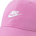 Nike pink baseball cap with white embroidered logo, shown in close-up detail.