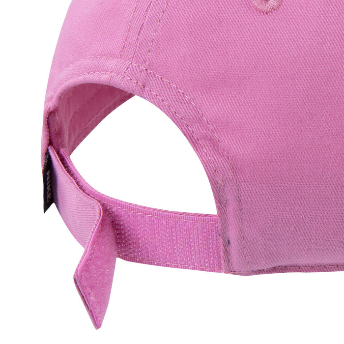 Nike pink cap close-up showing adjustable velcro strap and back opening against white background.