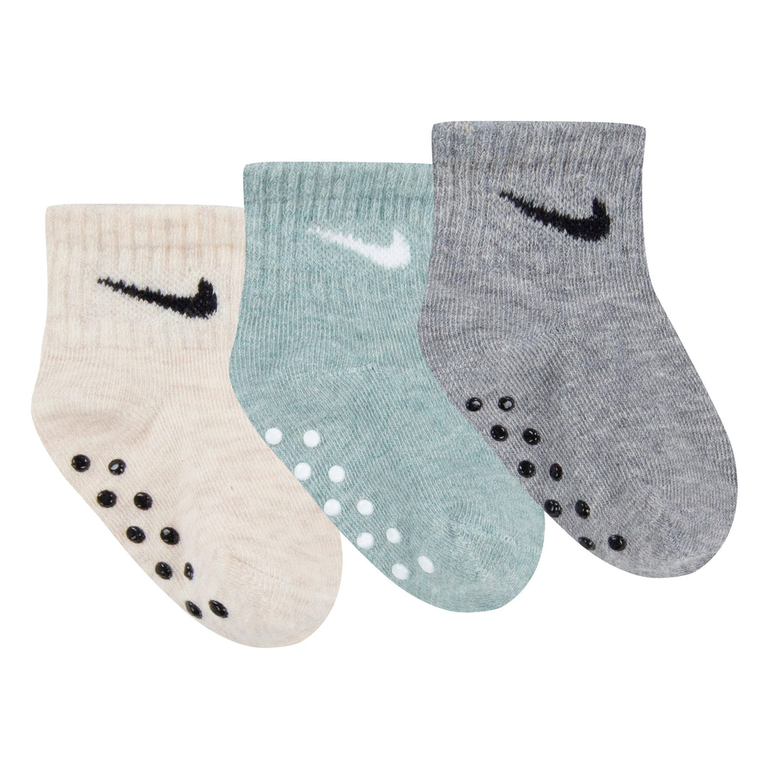 Nike baby grip socks set in beige, green, and grey, displayed side by side on a white background.