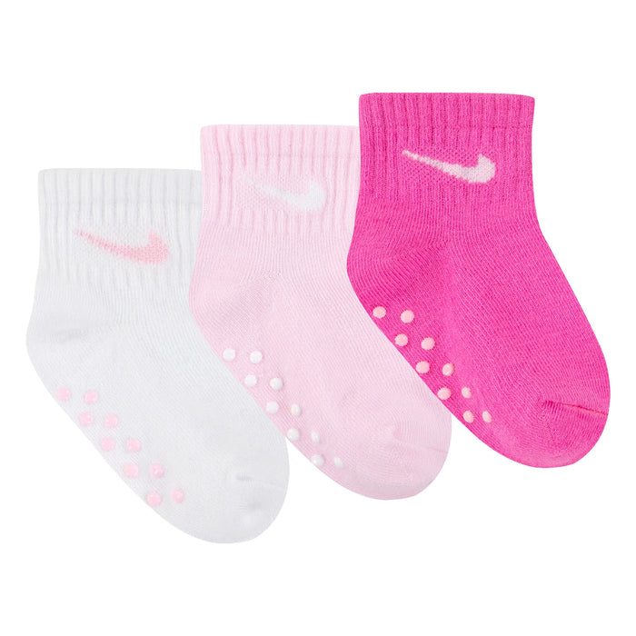 Nike baby socks set in white, pink, and bright pink displayed side by side on a white background.
