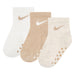 Nike baby crew socks in cream, beige, and white, shown in a set of three with anti-slip soles.