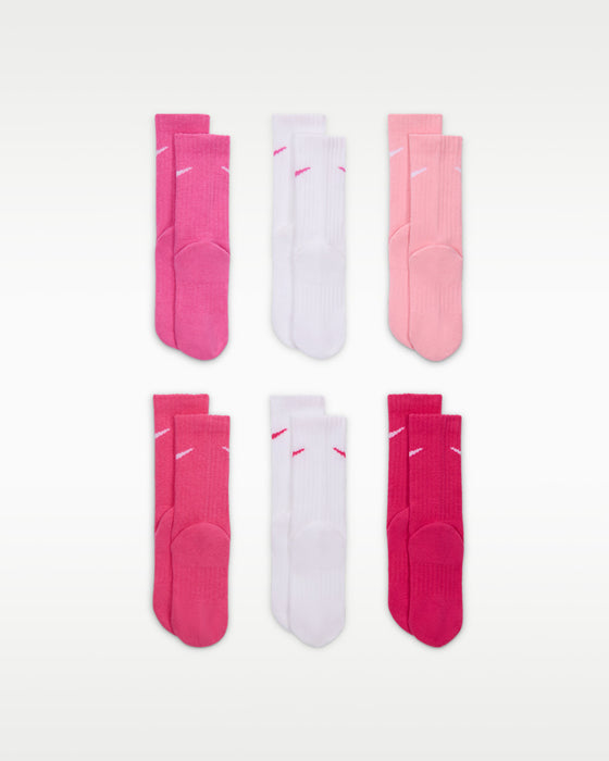 Nike Dri-FIT Performance Basic Crew kids’ socks in pink and white, displayed in three pairs on white background.