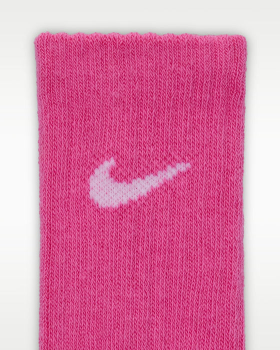Nike pink crew sock with white logo shown in close-up on a white background.