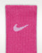 Nike pink crew sock with white logo shown in close-up on a white background.