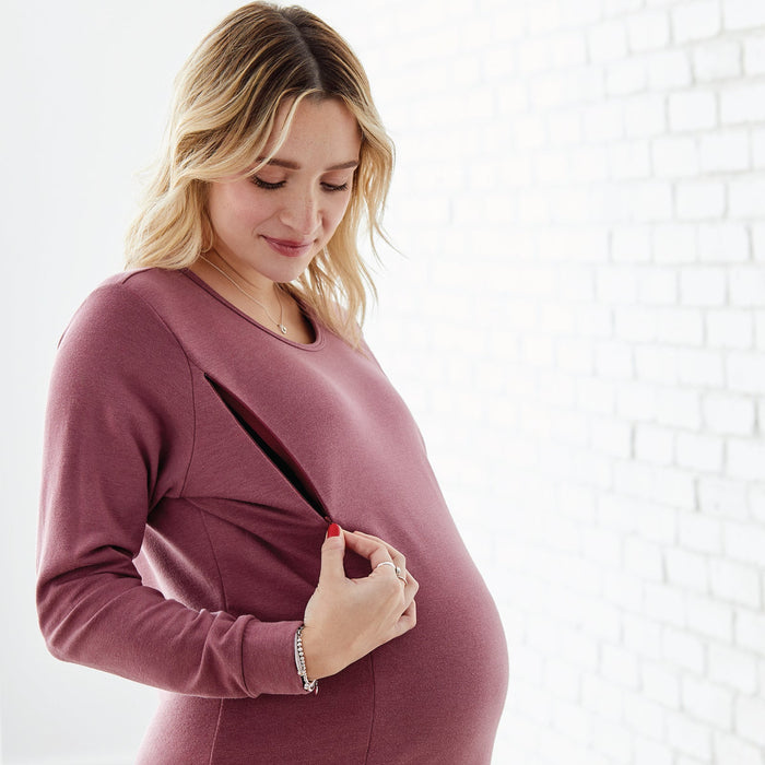 NIXI Lifestyle maternity top with side nursing zipper shown on a pregnant woman in a bright room.