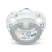 NUK baby pacifier with lion and bird illustrations shown upright on a white background.