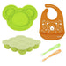 Kushies baby feeding set with green bear-shaped plate, orange bib, freezer tray, and two spoons on white background.