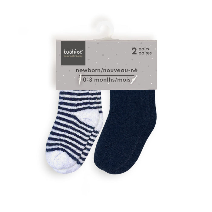 Kushies newborn socks two-pack with one striped and one solid navy pair on product hanger.