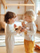 SP1050 Puppy Pull Along toy being played with by two toddlers in a brightly lit nursery.