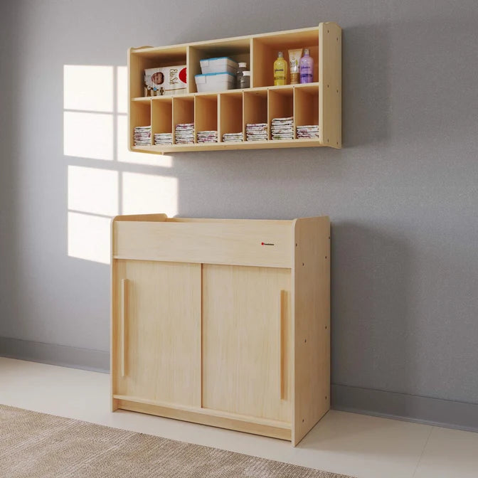 Table à langer Foundations® SafeGlide™ avec portes coulissantes et étagères de rangement