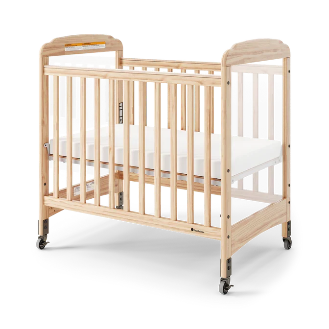 Natural wood clearview crib with mattress and wheels, ideal for daycare or nursery