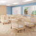 Clearview wooden cribs with wheels arranged in a bright daycare room with blue walls