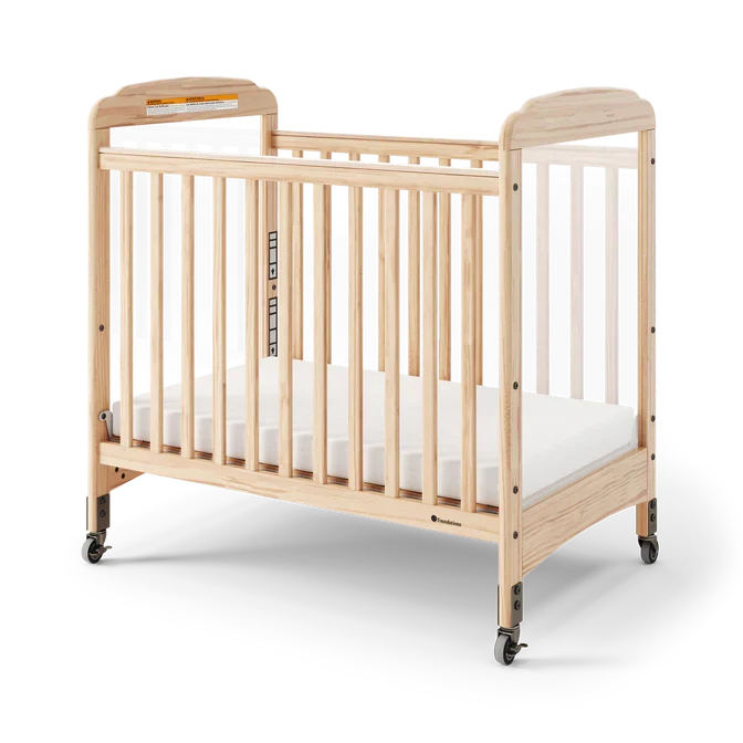 Natural wood clearview crib with casters and slatted sides for daycare or nursery use