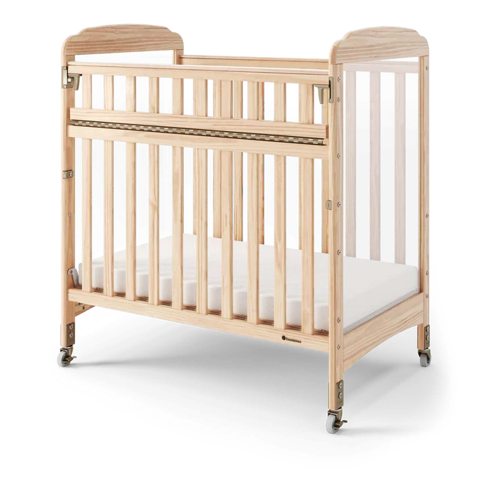Natural wood daycare crib with clear side panels and wheels for mobility