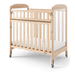 Natural wood daycare crib with clear side panels and wheels for mobility