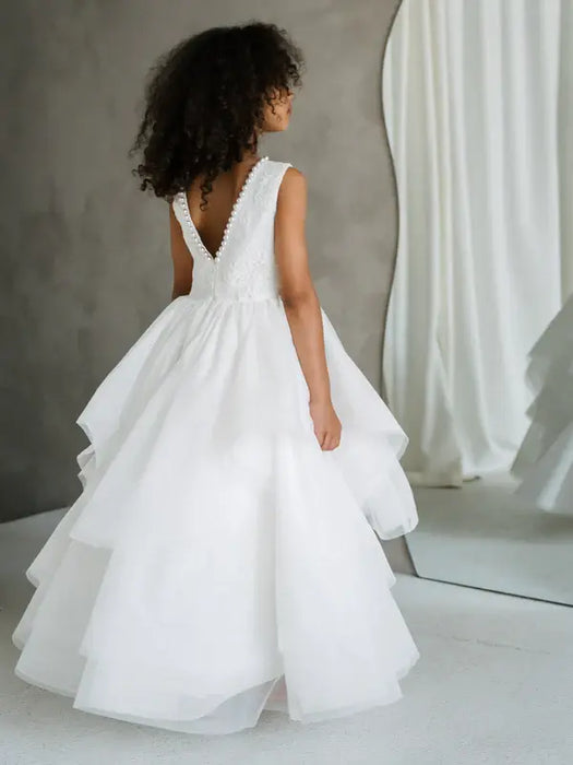 JK07 Pearl Back Horsehair Communion Dress shown on a girl standing in front of a mirror.