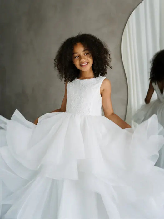 Sunny JK07 Pearl Back Horsehair Communion Dress worn by a young girl, shown twirling indoors.