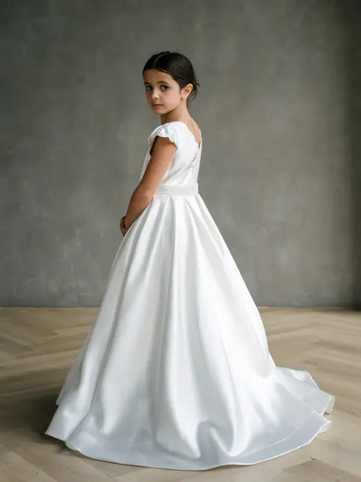 Teter warm Charlotte satin communion dress worn by a girl standing in a studio setting
