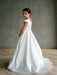 Teter warm Charlotte satin communion dress worn by a girl standing in a studio setting