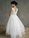 Teter Warm Lorelai Pearl Communion Dress shown on a girl standing indoors with lace and tulle details.