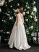 Teter warm off-white communion dress shown on a girl standing in front of a decorated Christmas tree.