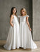 Teter warm off white communion dress shown worn by two girls standing indoors against a gray wall.