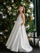 Teter warm off white communion dress worn by a girl standing beside a decorated Christmas tree.
