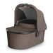 UPPAbaby bassinet in brown fabric with sun canopy, shown on a white background.