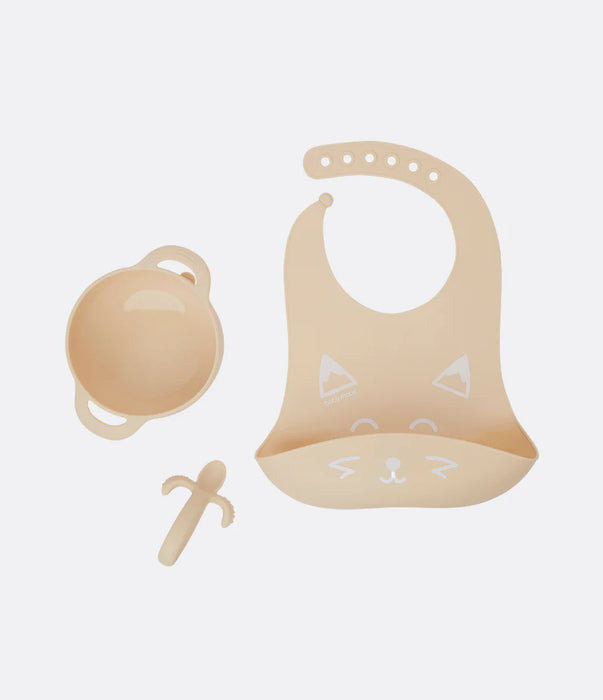 Beige silicone baby feeding set with bowl, bib with animal face, and teether on white background