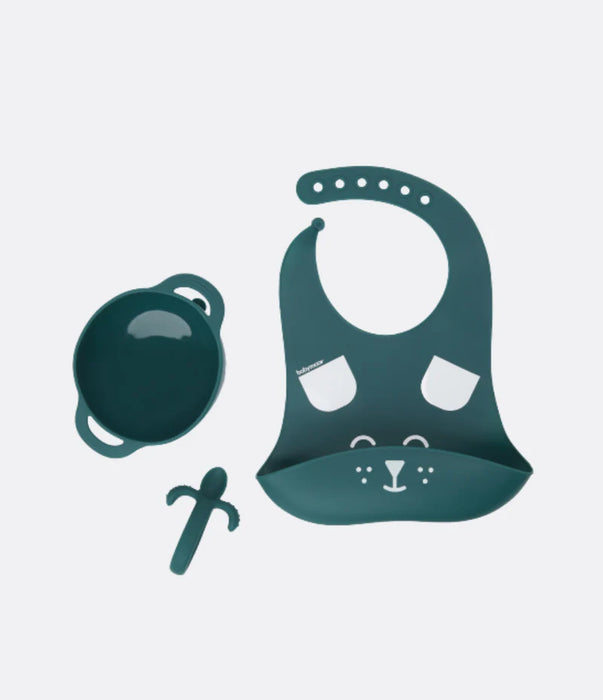 Teal silicone baby feeding set with bowl, animal face bib, and teether on white background